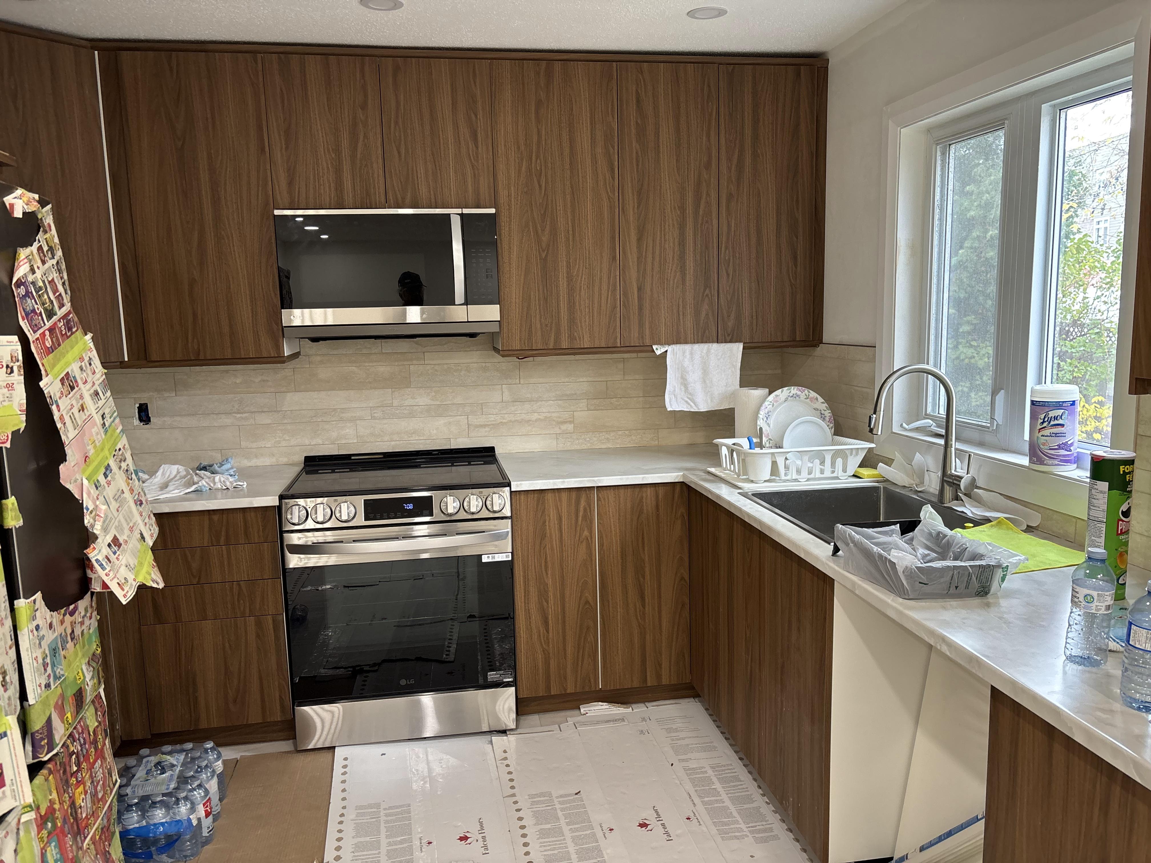 Spacious kitchen renovation by 613Pro - beige cabinets, wooden island, open layout